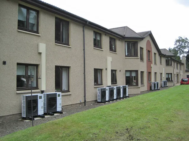 A heat pump unit fixed outside a home — most Leicester homes get a monobloc, with everything sealed in this outdoor box.