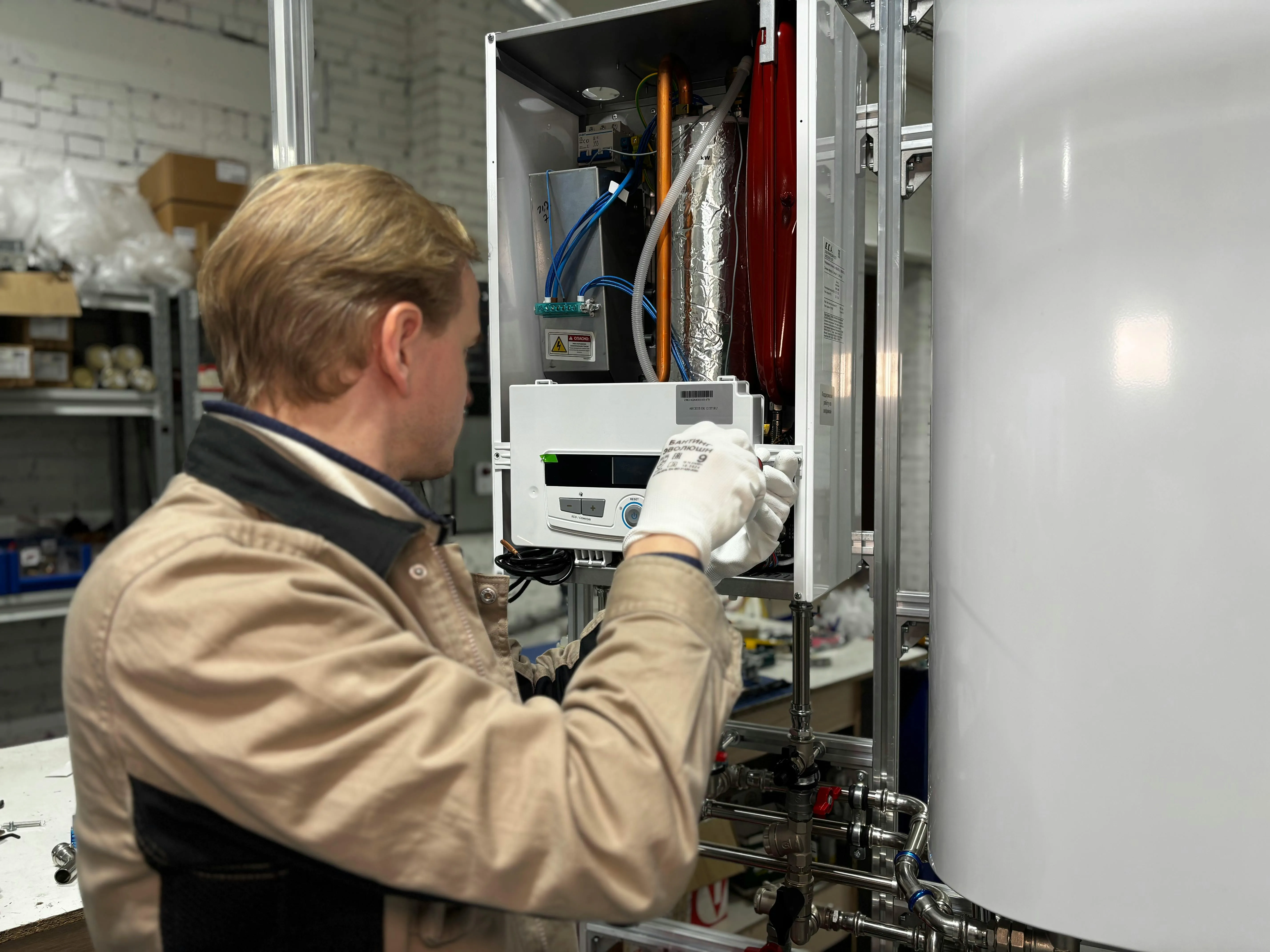 An engineer working on a heat pump installation