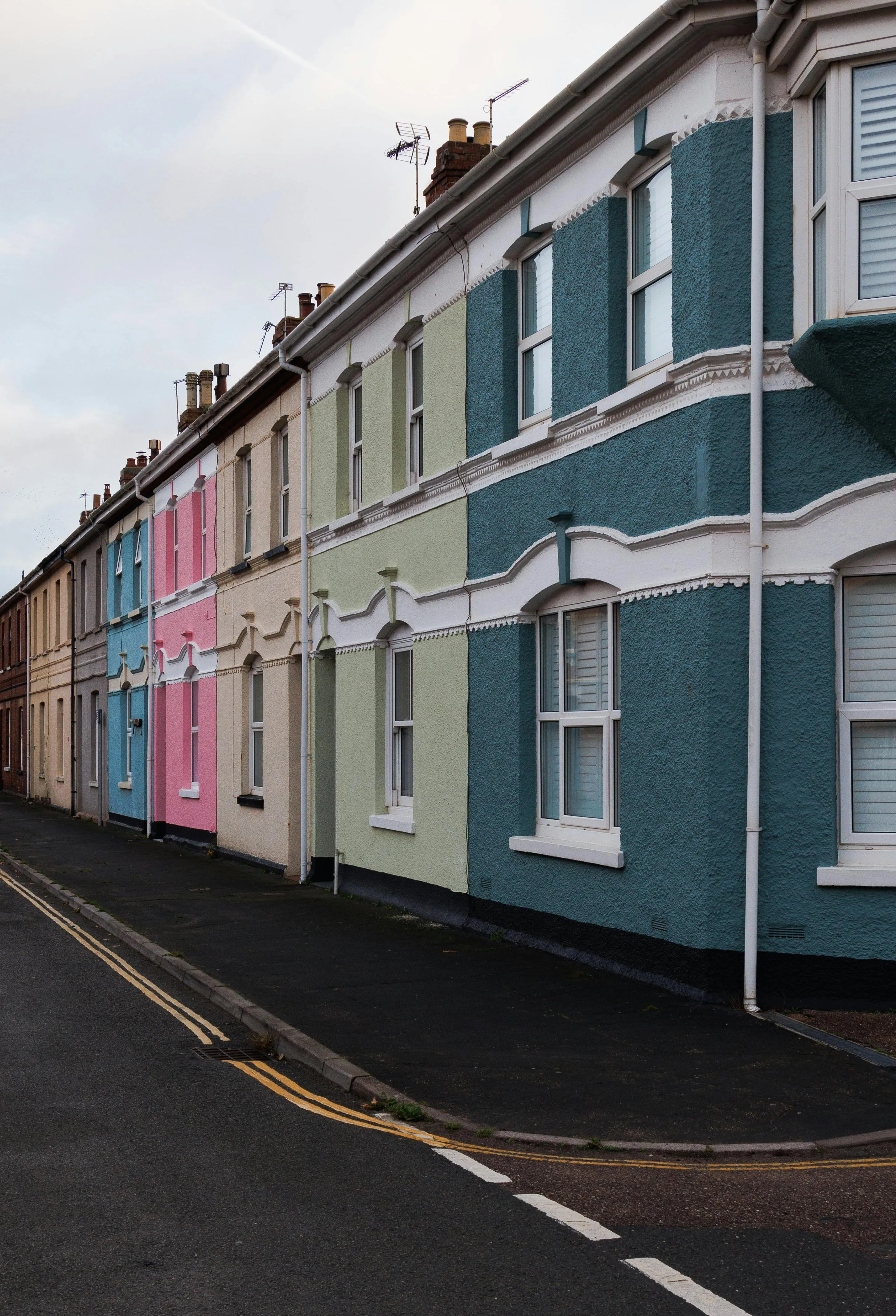 A row of Victorian terraces on a frosty tree-lined Leicester street — nearly all homes like these can claim the heat pump grant.